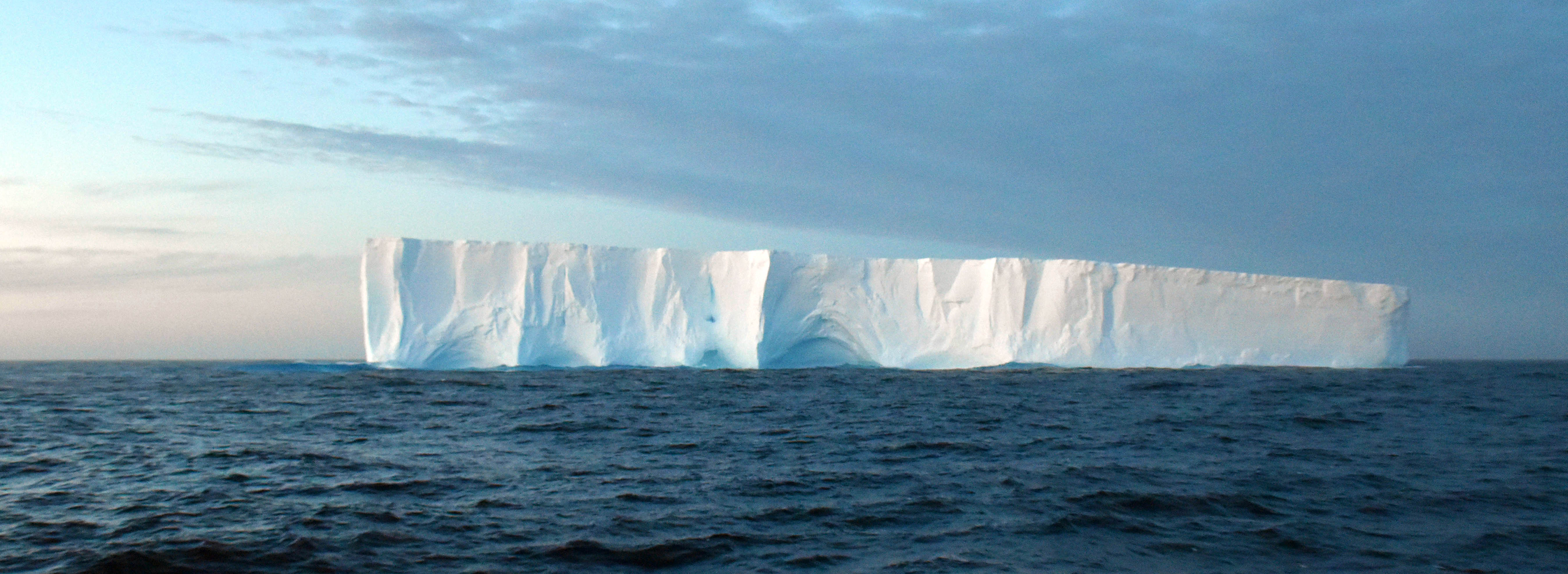 A large tabular iceberg floating on the Southern Ocean, Antarctica, at sunrise 