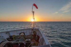 Sunrises over the ship's bow