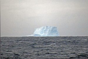 A large blocky iceberg on the horizon