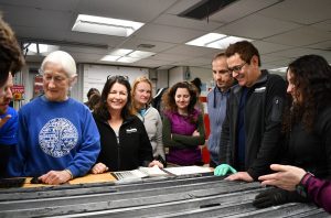 Co-chief scientists Mo Raymo (center left) and Mike Weber (right) gather with the scientists of Expedition 382 to look at the new cores on the description table.