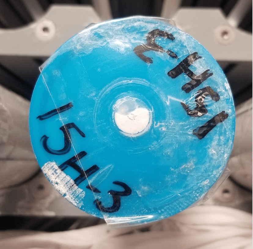 The blue cap of a core liner. The cap is labelled with the core's ID number - 15H-3.