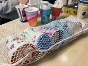 Children's shrunken cups in a laundry bag