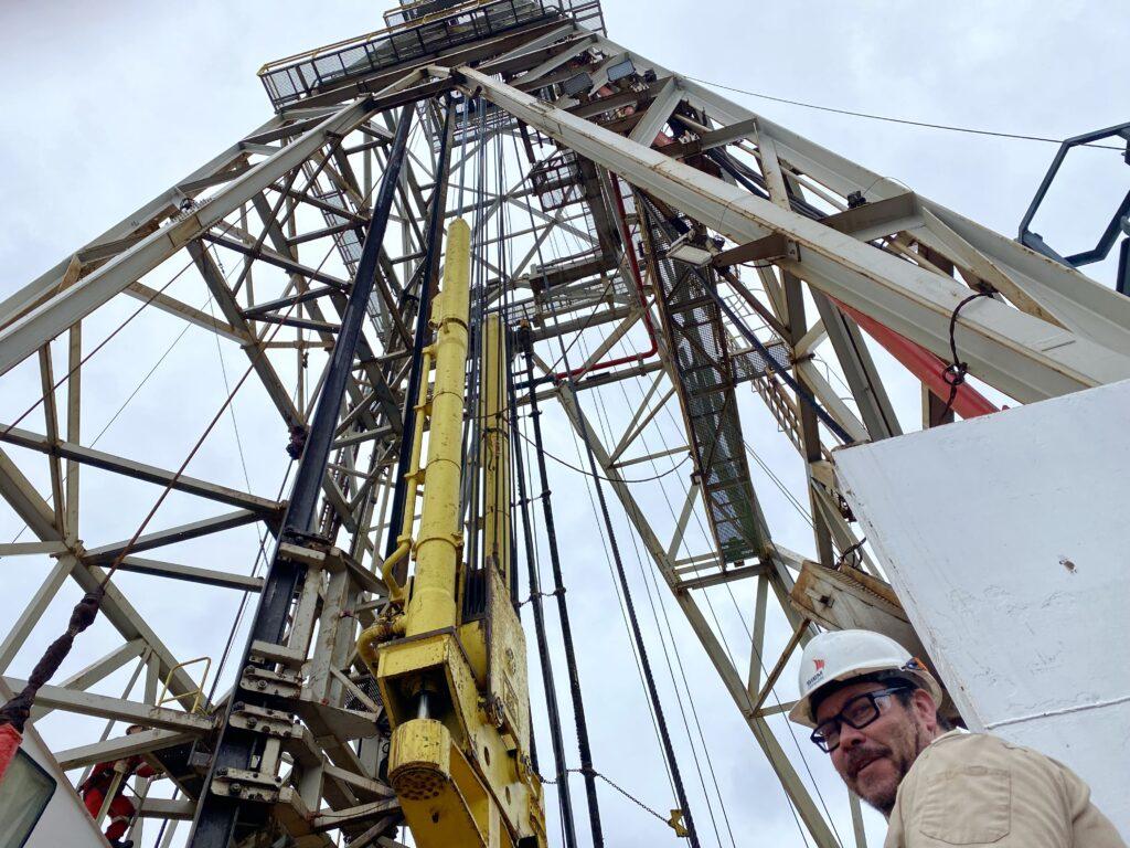 View from below the derrick, looking up, with Glenn's face in the bottom right corner