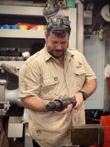 Glenn looks at a component of the advanced piston coring system in the core tech shop