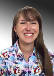 Headshot of Laurel wearing a Hawaiian shirt featuring Buckee.