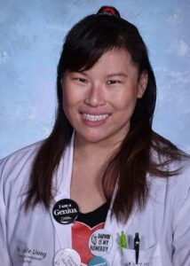 Headshot of Leslie wearing a labcoat.