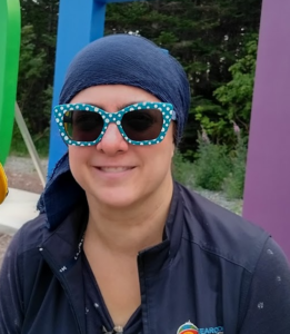 Headshot of Sharon Cooper, wearing blue and white polka dot sunglasses.