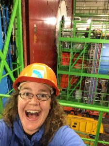 Headshot of DaNel Hogan wearing a hardhat at the large hadron collider.