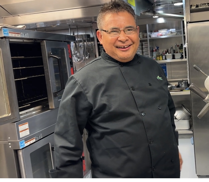 Smiling chef with glasses.