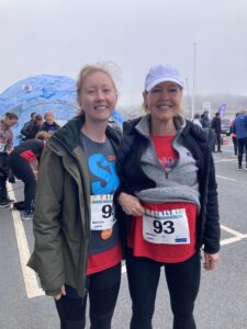 Beth and Margaret finish a running race and pose for a photo