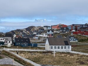 Colorful houses with a mountain and clouds behind