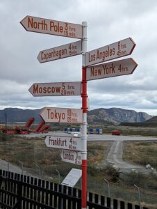 Sign post to cities far away from Greenland