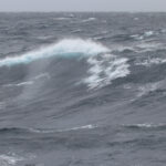 Whitecaps on a gray ocean and sky