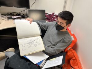 Chemistry Lab Specialist Oscar Cavazos holds up a diagram