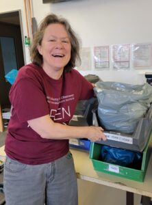 Dr. Sid Hemming grins as she holds up a box of bagged-up samples.
