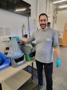 Dr. Tom Dunkley-Jones smiles as he hoists a heavy-looking bag of samples.