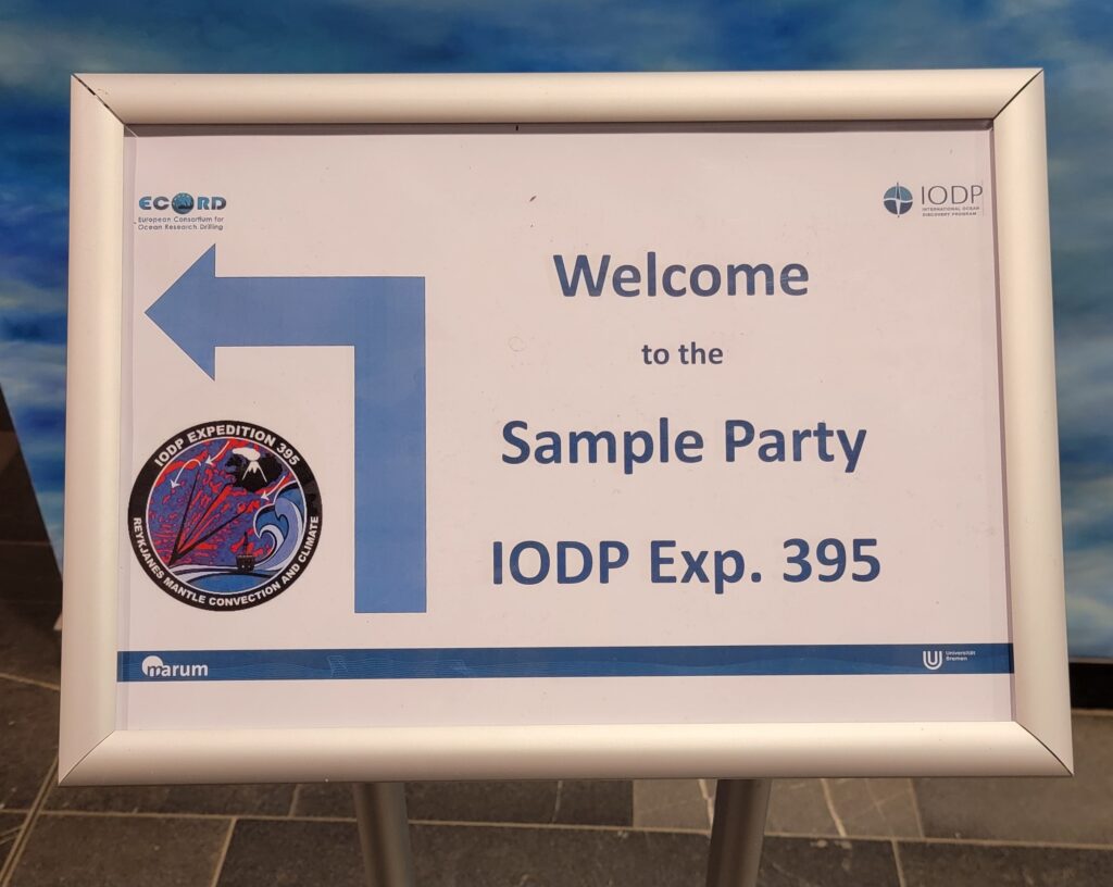 Sign with arrow and text that says "Welcome to the Sample Party IODP Exp. 395"