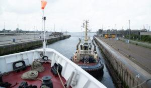 The Bow of the JOIDES revolution looks out into the North Sea, guided by a tugboat on the port side. 